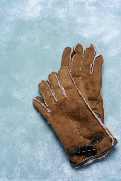 istock Knit gloves on wooden board 1075854948