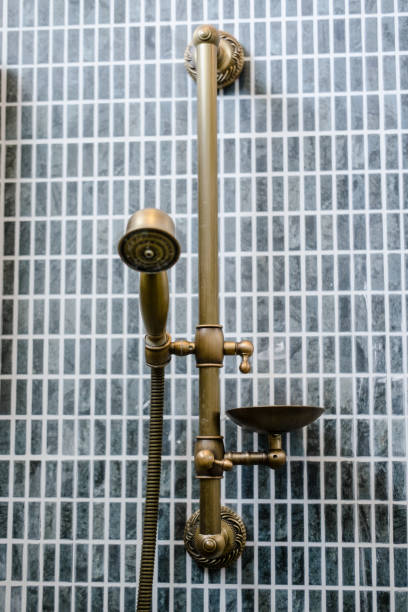 istock Unlacquered brass shower set, gray bathroom tile 1075858776
