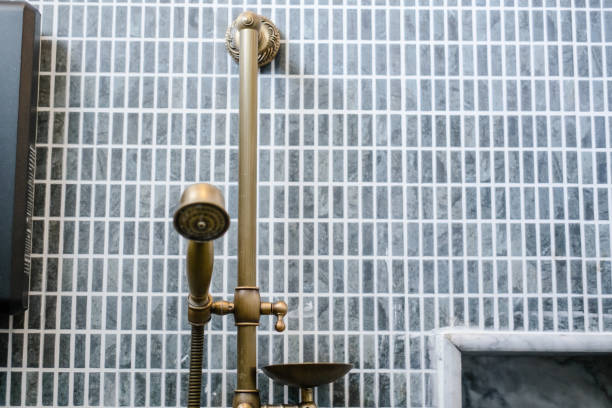 istock Unlacquered brass shower set, gray bathroom tile 1075858778
