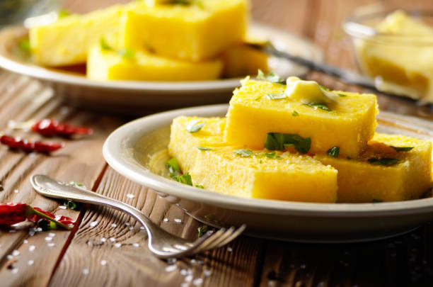 istock Polenta with butter and greens on clay dish on wooden rustic table 1075870054