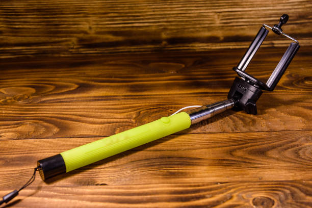 istock Selfie stick with adjustable clamp on a wooden table 1075873210