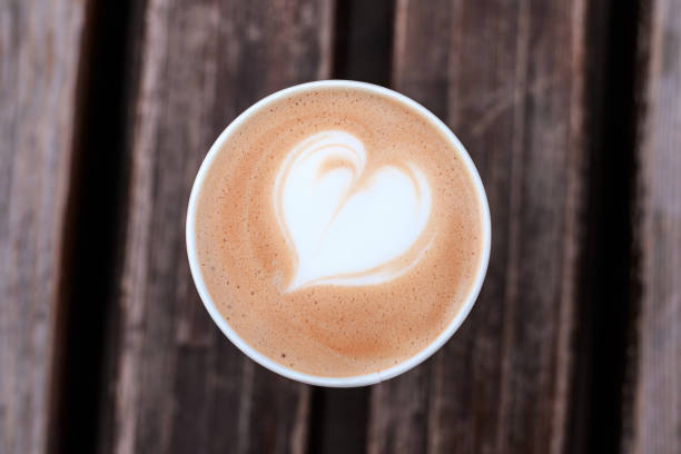 istock Cup of fresh cappuccino on wooden background. 1075874616