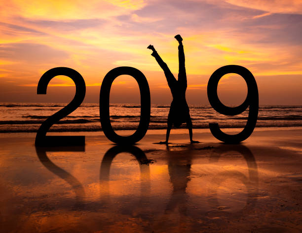 Happy person silhouette in New Year 2019 Happy person silhouette in New Year 2019 at the sunset in beach 2019 new year resolution stock pictures, royalty-free photos & images