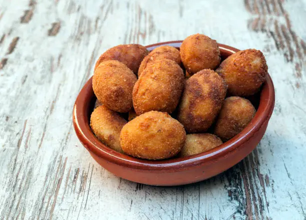 Croquettes surrounded by rustic background