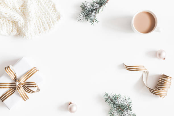 istock Christmas composition. Gift, fir tree branches, plaid, cup of coffee, balls on white background. Christmas, winter, new year concept. Flat lay, top view, copy space 1075884588
