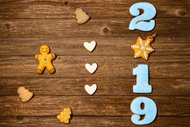 istock Gingerbread cookies over wooden background. Flat lay festive composition with copy space. 1075889808