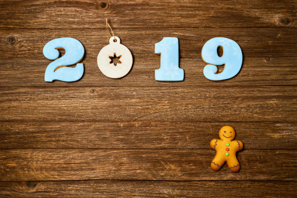 istock Gingerbread cookies over wooden background. Flat lay festive composition with copy space. 1075900122