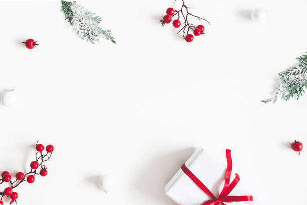 istock Christmas composition. Frame made of gift, snowflakes, fir tree branches and red berries on white background. Christmas, winter, new year concept. Flat lay, top view, copy space 1075900634
