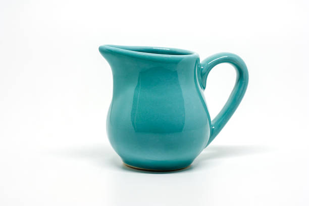 istock Green small ceramic pitcher on white background for utensil and dishware concept 1075902780