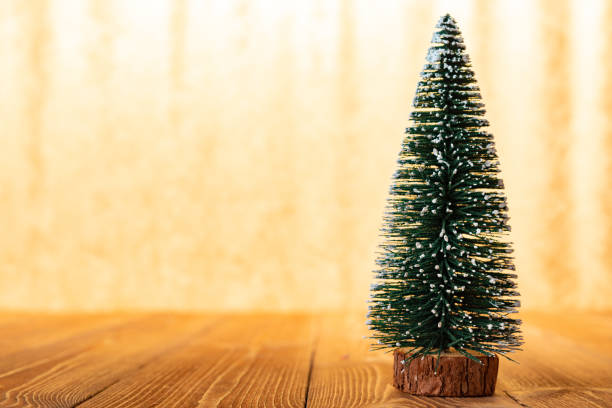 istock Christmas tree model in front of a bright golden background 1075903546