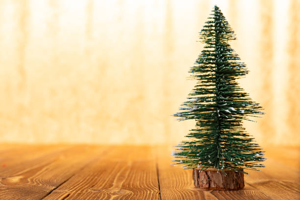 istock Christmas tree model in front of a bright golden background 1075903858