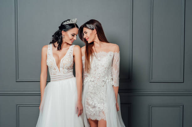 istock Smiling ladies in white dresses 1075907986