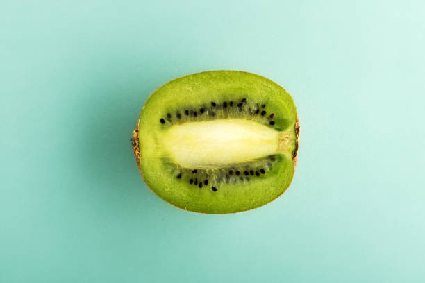 istock Half of the kiwi on cyan background 1075913930