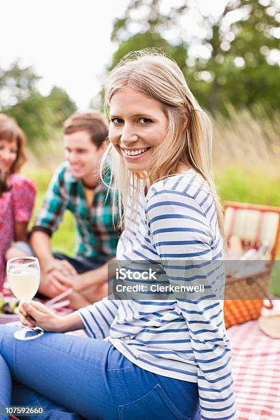 Portrait Of Smiling Woman With Group Of Friends Having A Picnic Stock Photo - Download Image Now