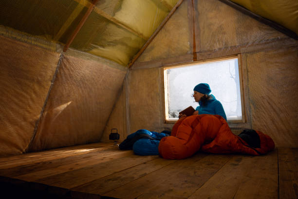traveler, woman rests in the old mountain hut - home interior cabin shack european alps imagens e fotografias de stock