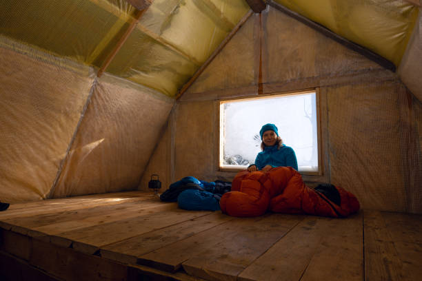 happy traveler, woman rests in the old mountain hut - home interior cabin shack european alps imagens e fotografias de stock