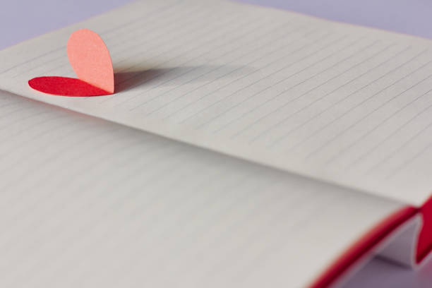 istock Opened blank notebook and red paper heart 1075932288