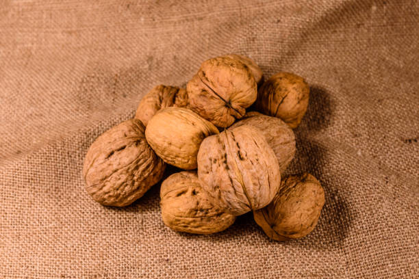 istock Heap of the walnuts on a sackcloth 1075932416