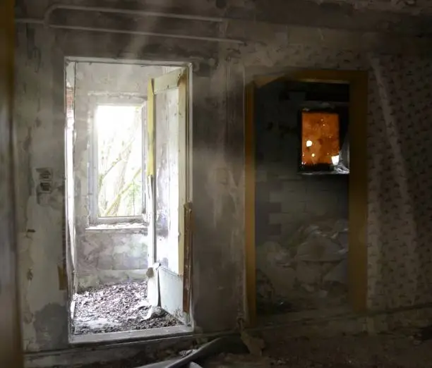 old abandoned house with sunlight at the window