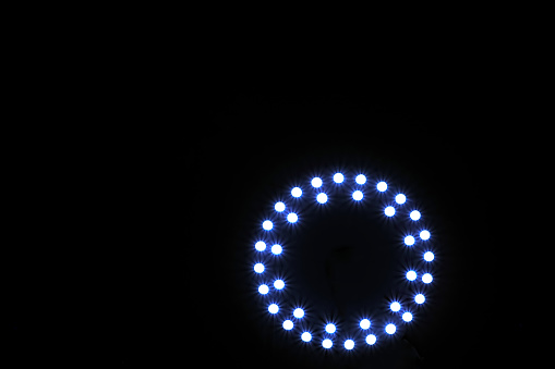 blue led spotlight aranged in circle on black background