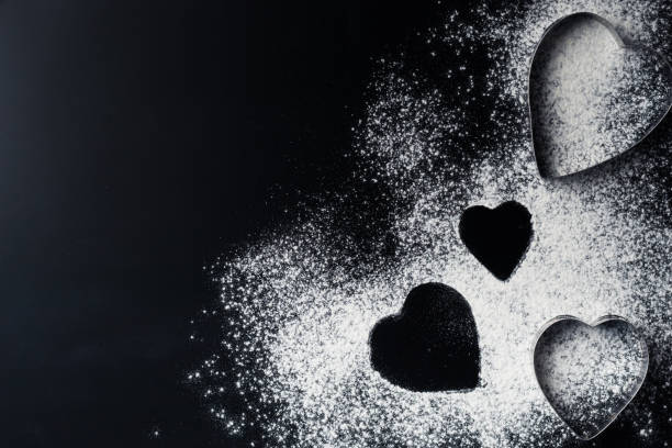 istock Baking background with heart shape and flour on a dark table with copy space, top view 1075951386