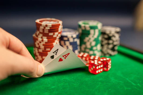 istock playing cards,dices and poker chips on green poker table 1075952996