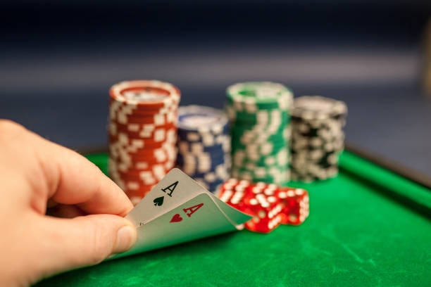 istock playing cards,dices and poker chips on green poker table 1075953010