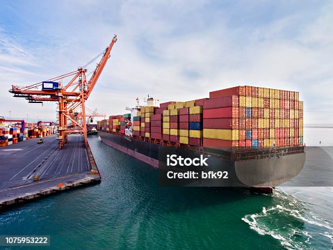 istock Aerial view of cargo ship in transit. 1075953222