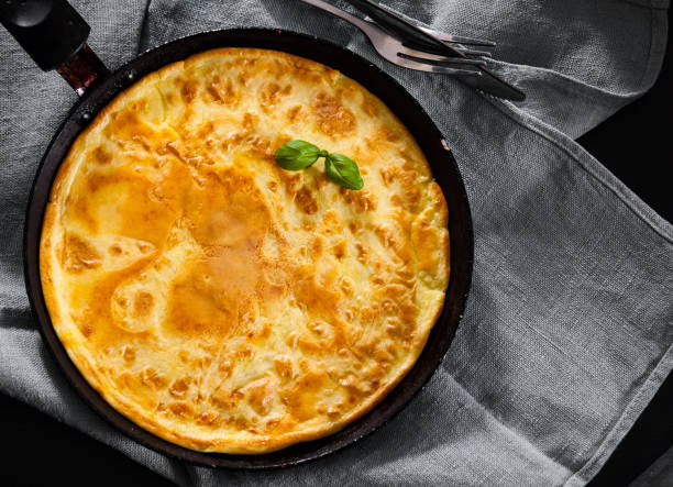 istock eggs omelette in a frying pan on wooden table 1075965500