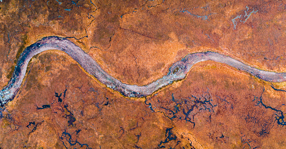 A dramatic curved river landscape in Scotland seen from directly above.