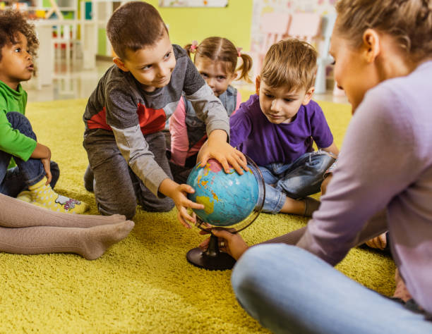 istock Small kids having geography class at preschool. 1075965784