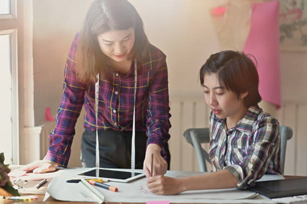 istock Two Asian fashion designer working in the studio 1075969202