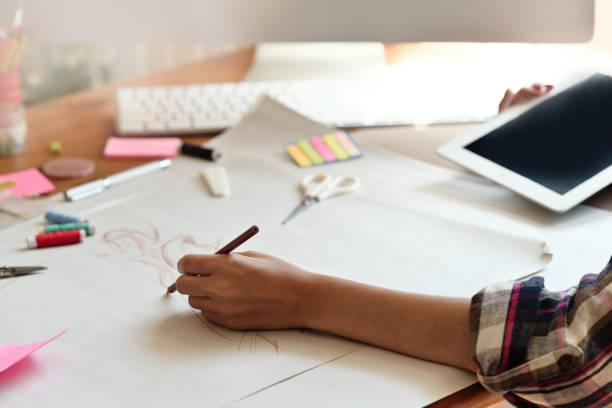 istock Female illustrator drawing sketches in atelier. 1075969906