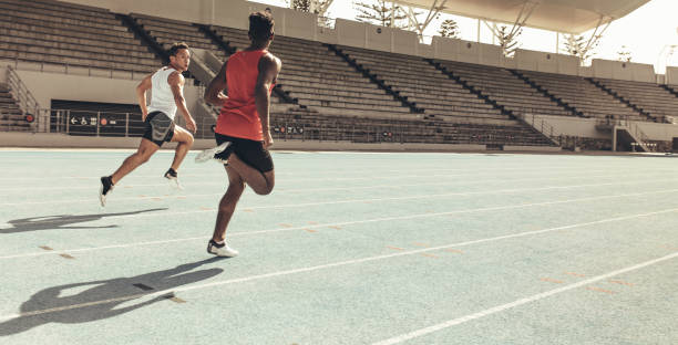 istock Athletes running a race in a track and field stadium 1075970036