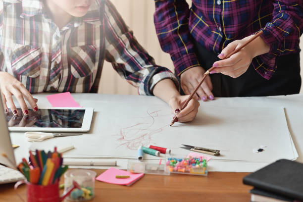 istock Attractive teamwork Asian female fashion designer is working in workshop 1075970152
