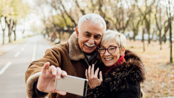 istock Couple hugging and taking a selfie 1075970572