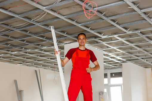 Construction worker wear safety uniform installation ceiling work
