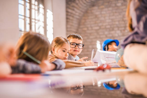 istock Group of small creative kids working in the office. 1075980750