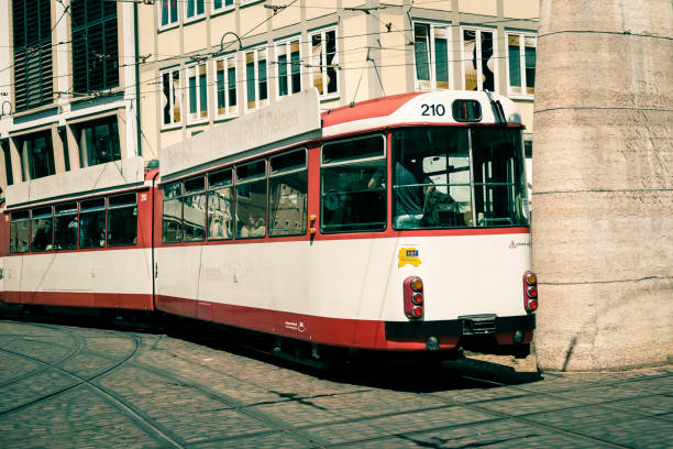 Tram passing through shopping area in rain