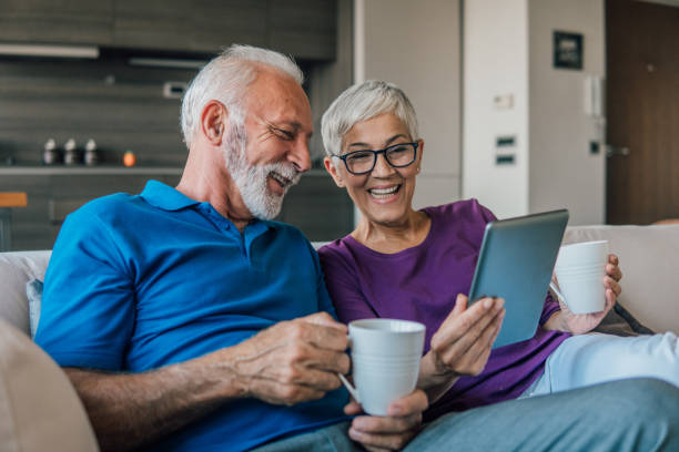 istock Mature couple looking at digital tablet 1075982374