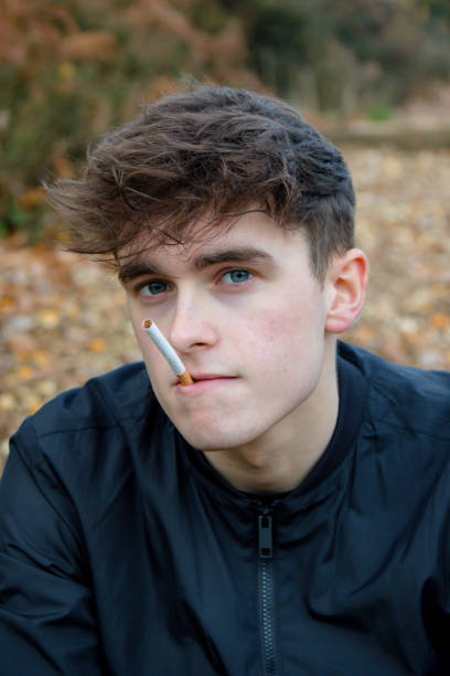 istock Young adult smoking outside 1075990586