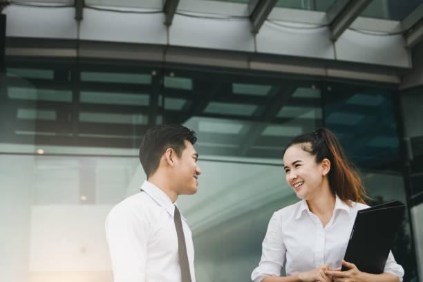 istock Two business people talking together at office building. 1075991366