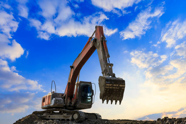 istock Excavator in construction site on sunset sky 1075993026