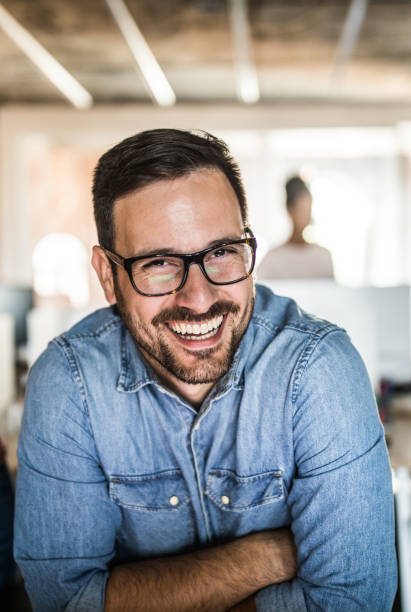 istock Happy businessman with crossed arms looking at camera. 1075995034