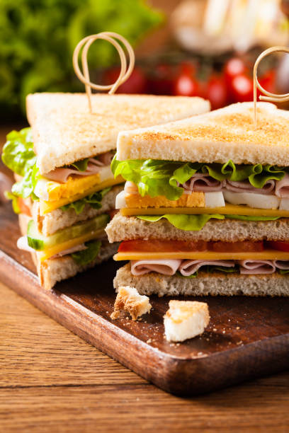 istock Delicious toast sandwich with ham, cheese, egg and vegetables. 1075995636