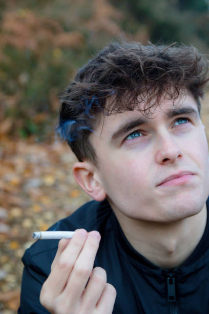 istock Young adult smoking outside 1075997526