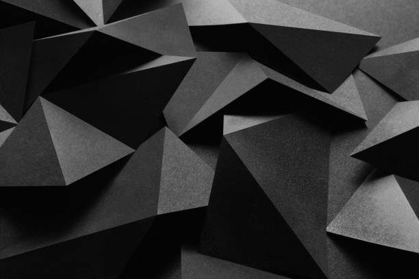 istock Close-up of triangular shapes of paper, dark background 1075997850