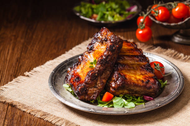 istock Roasted ribs, served on an old plate. Dark or balck background. 1075998524
