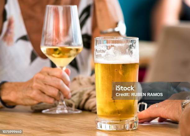 Hands Of A Couple Having Beer And White Wine Sitting In A Table Outdoors A Bar In Spli Croatia Stock Photo - Download Image Now