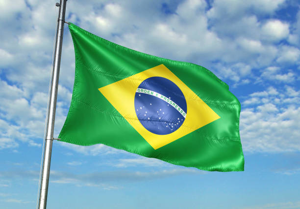 istock Brazil flag waving cloudy sky background realistic 3d illustration 1076016202